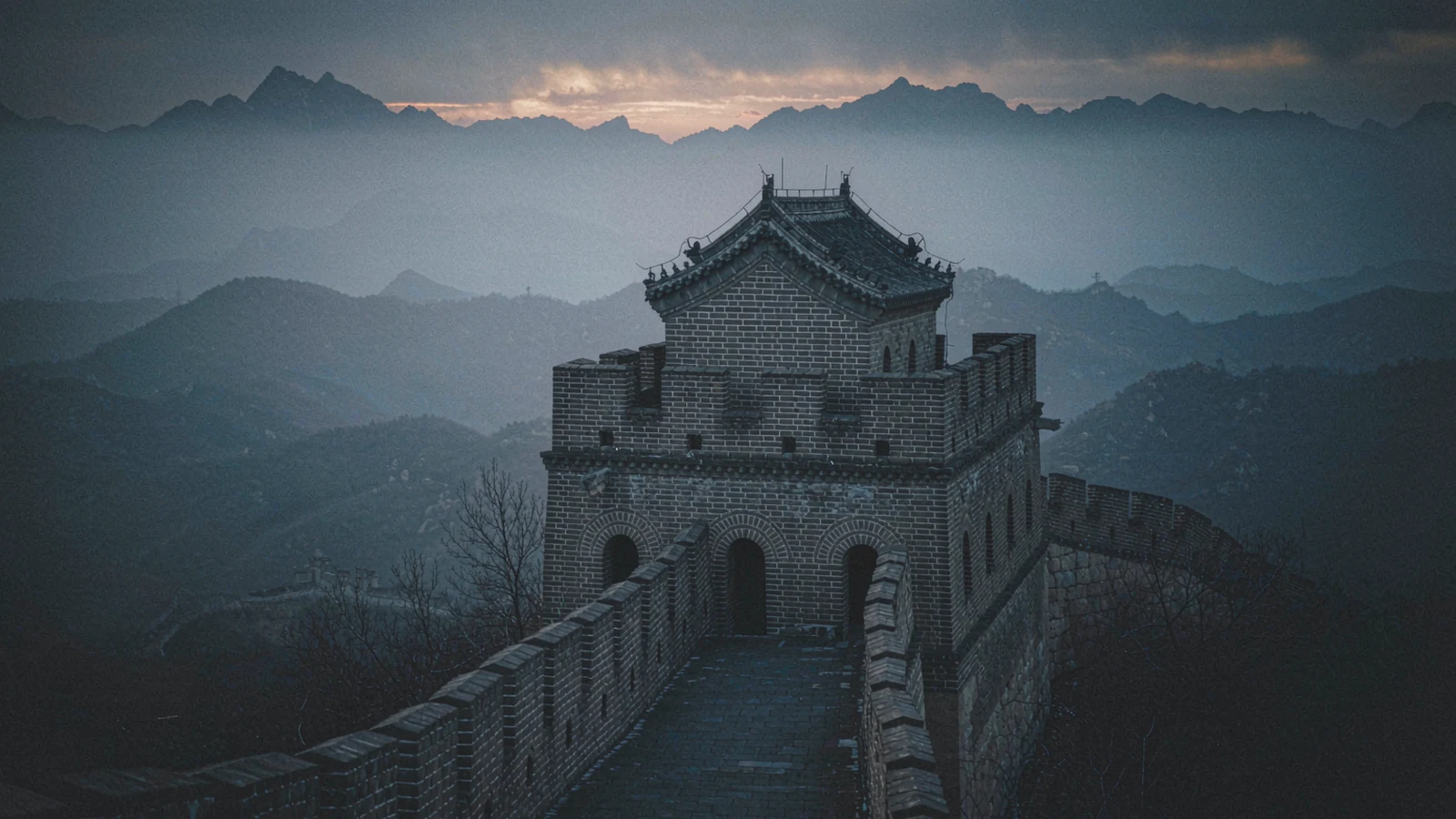 Section of the Great Wall at Mutianyu at dawn, low light on the watchtowers