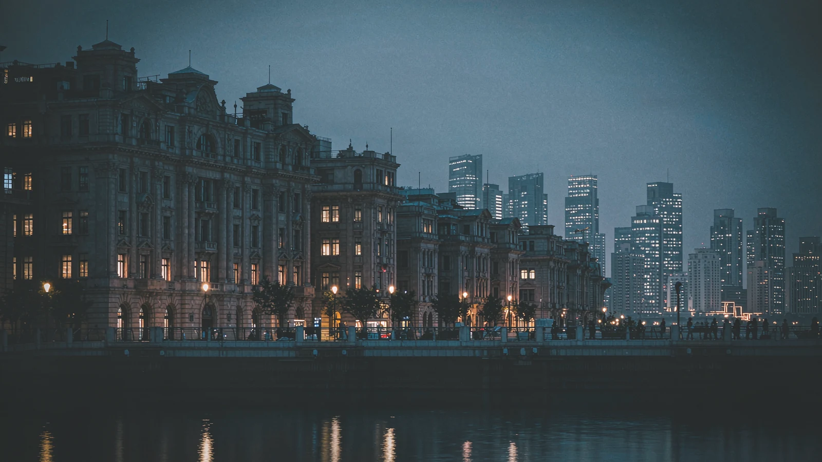 The Bund at dusk, the bank façades of the old concession lit up and the Pudong towers across the river