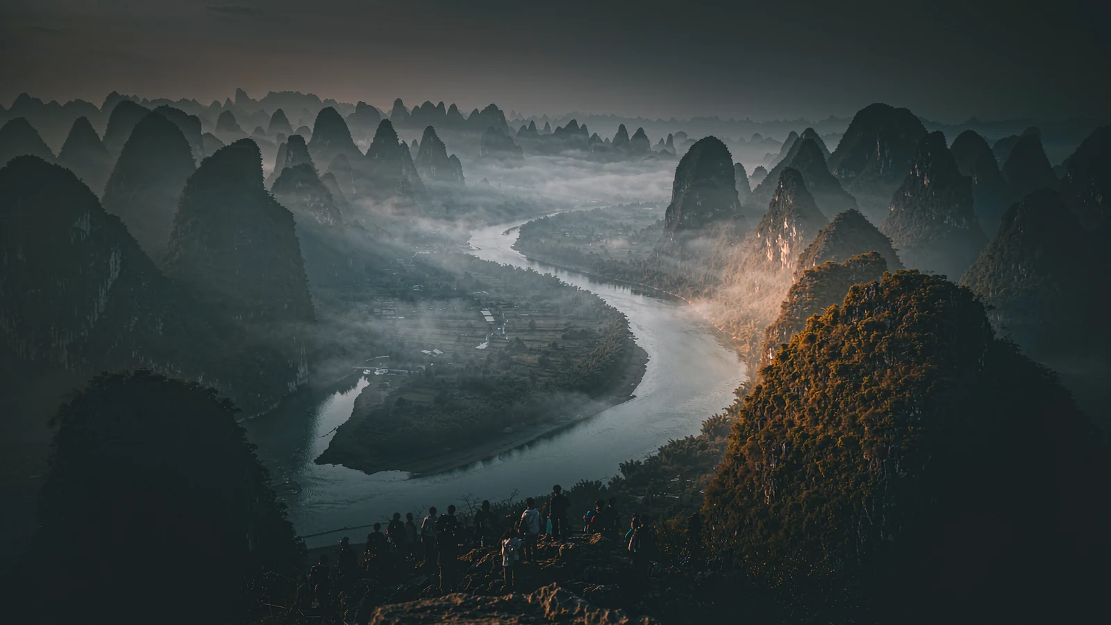 The great bend of the Li River seen from the Xianggong viewpoint, karst peaks rising out of the mist